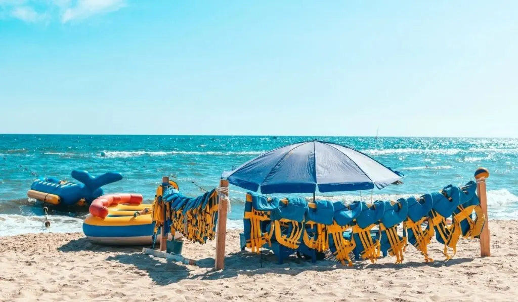 rafting boats and life jackets at the beach shores