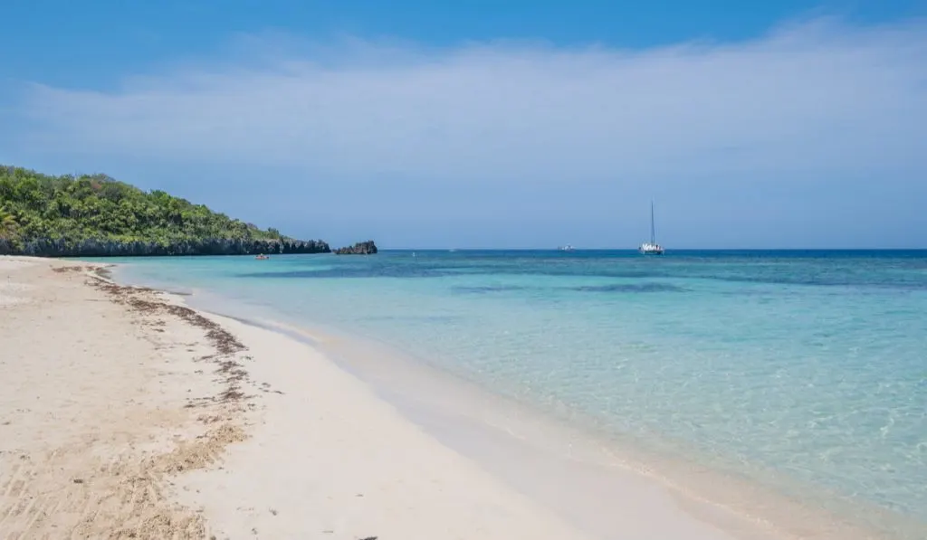 beautiful beach white sand clear blue water sky roatan