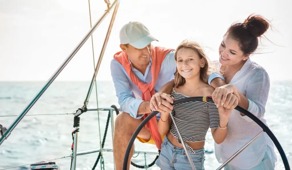 Happy family on a sailboat trip