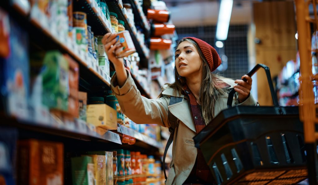 Young woman shopping groceries in the supermarket